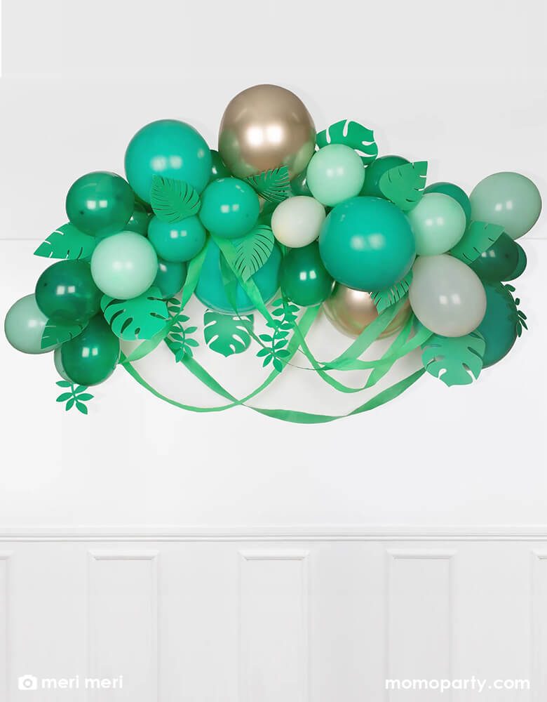 Meri Meri leafy balloon arch including 44 balloons, including 44 balloons in the different shades of green, gold and ivory, paper leaves and crepe paper streamers, it is the perfect backdrop for a safari, jungle, or dinosaur party.