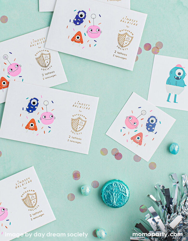 Little Monsters Temporary Tattoos and candies, confettis, on a mint table. Made by Jollity & Co Party Boutique - Daydream society collection, they are perfect for Little Monsters themed birthday party, halloween party or monster inc themed birthday party