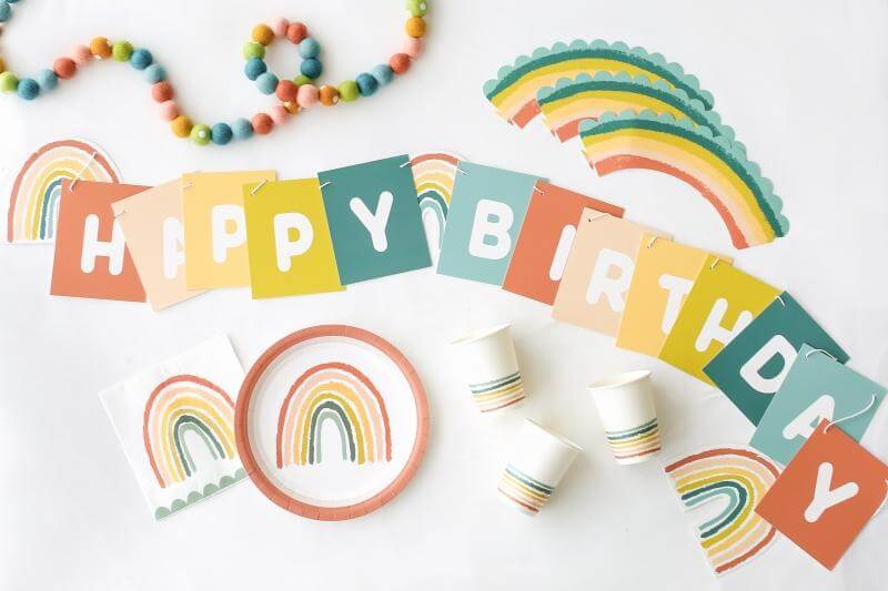 A flat lay shot of Lucy Darling's little rainbow party in a box including rainbow themed tabletops