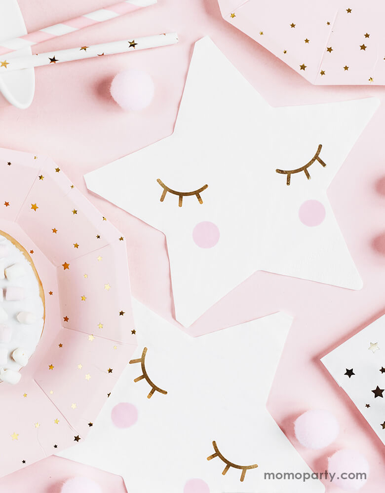 An adorable pastel pink table filled with star-shaped napkins, baby pink plates with star designs and a mix of pink striped straws and gold star straws for a Twinkle Twinkle Little Star themed party 