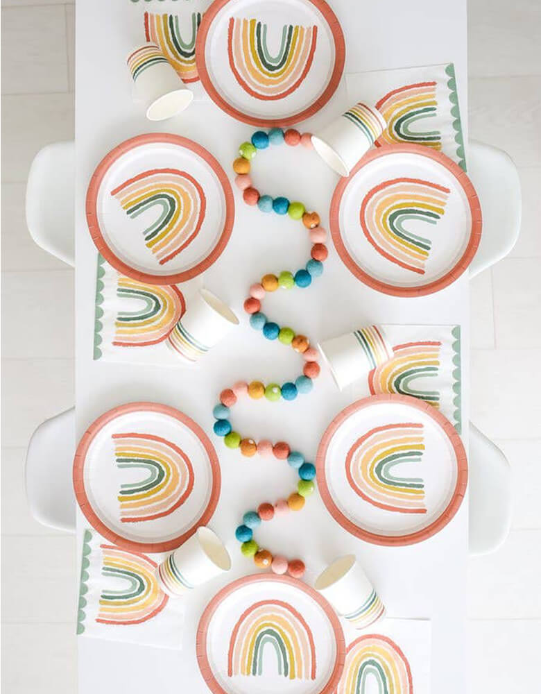 A modern party table flat lay shot filled with Lucy Darling's rainbow themed tabletops 