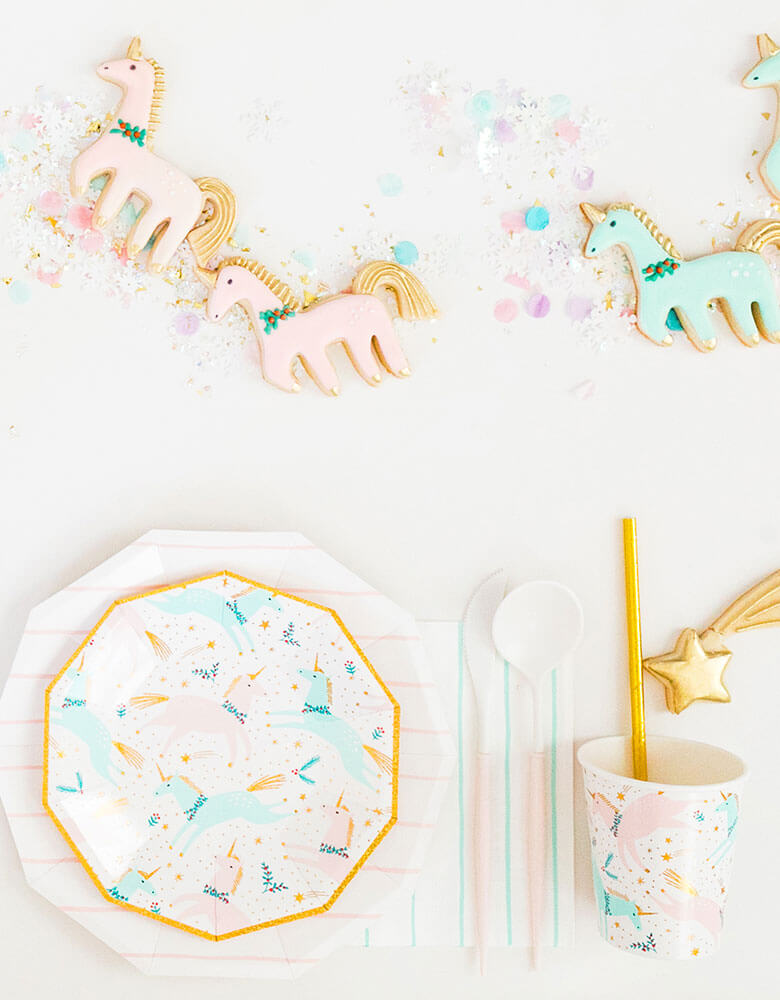 Daydream Society Magical Christmas Tableware featuring unicorn illustrations in pastel colors for a Holiday dinner party decorated with matching sugar cookies