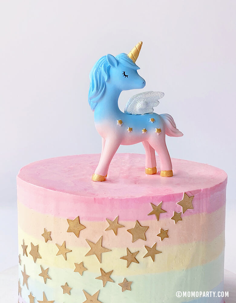 Magical Unicorn Cake Topper,  4 inch tall, with blue and pink color, gold horn and gold stars on the body on a pastel rainbow star cake. Unicorn toys, Unicorn display toy for a Unicorn lover and rainbow birthday party, unicorn birthday party