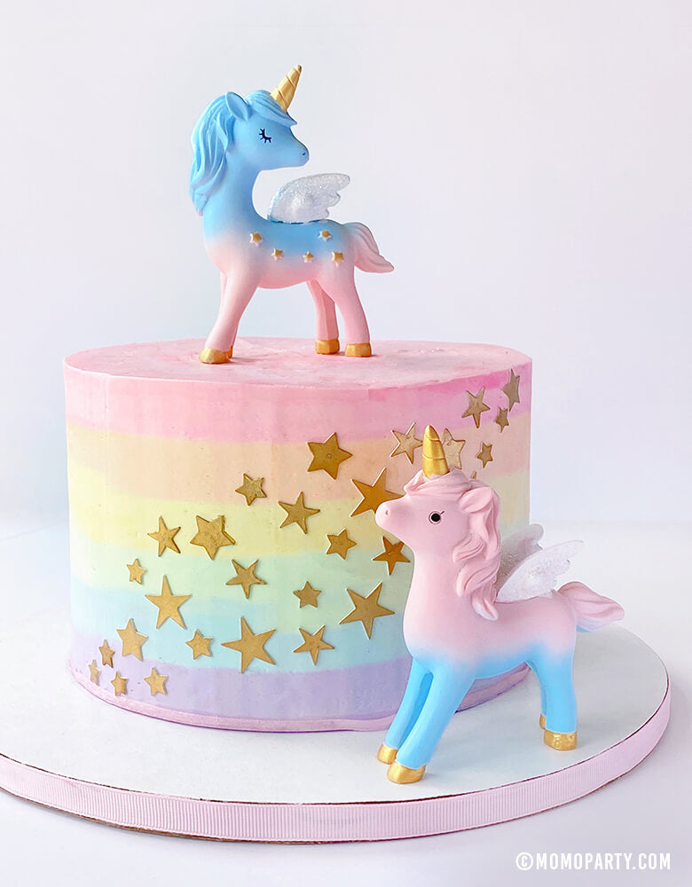 2 Magical Unicorn Cake Toppers, 4 inch tall, with blue and pink color, gold horn and gold stars on the body on a pastel rainbow star cake. Unicorn toys, Unicorn display toy for a Unicorn lover and rainbow birthday party, unicorn birthday party
