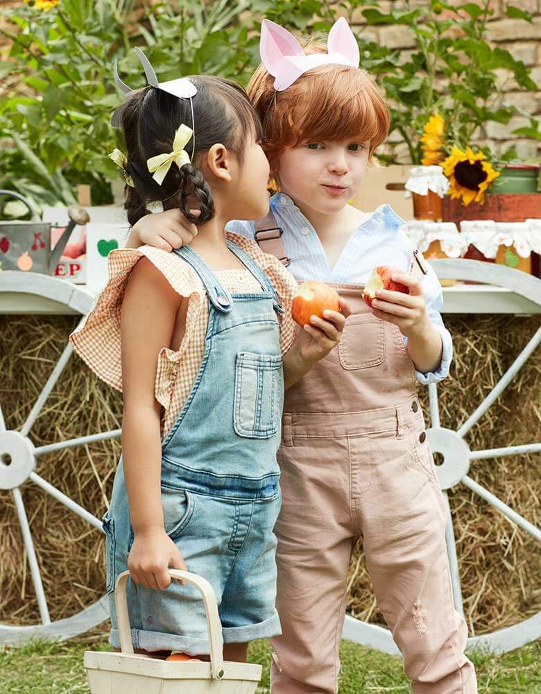 Kids in a farm themed party with Meri Meri's On The Farm Animal Ears of a pig and cow