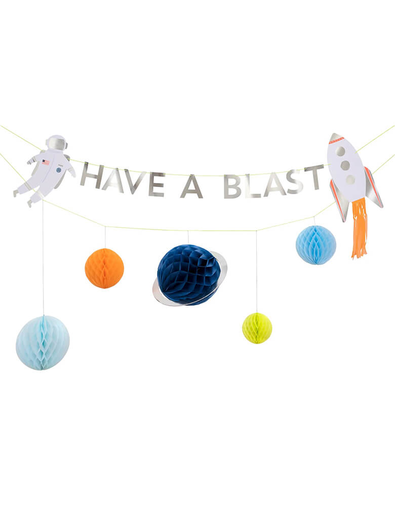 Meri Meri space garland set featuring honeycomb planets in the color of blue, orange, light blue and yellow, an astronaut and a rocket ship with neon orange tassel, perfect decoration for a space or galaxy themed birthday party