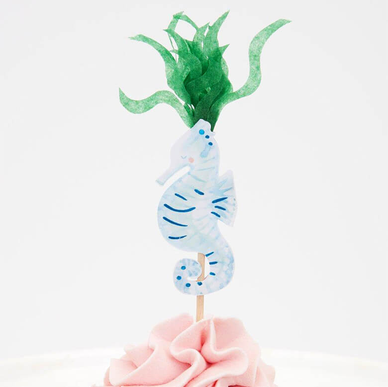 Meri Meri Mermaid Cupcake Kit topper with a watercolor illustrated pastel blue sea horse and tissue paper made seaweed design