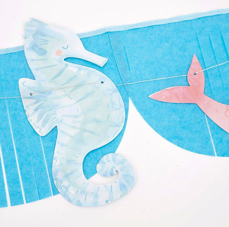 close up details of Mermaid Fringe Garland, with a watercolor seahorses design
