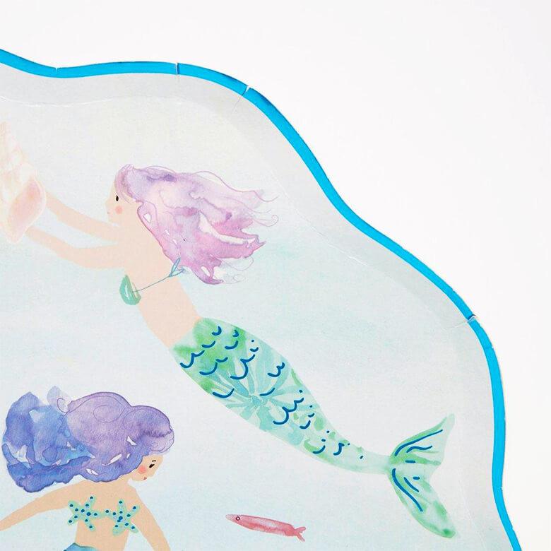 Details of Meri Meri Mermaid Swimming Plates. featuring a beautiful watercolor illustrated mermaids swimming in the sea, with shimmering blue foil detail on the edge of the plate. The plate crafted in a sensational shell-shaped design. This gorgeous shell-shaped plate has so much details, it will look amazing at a mermaid party or under-the-sea party