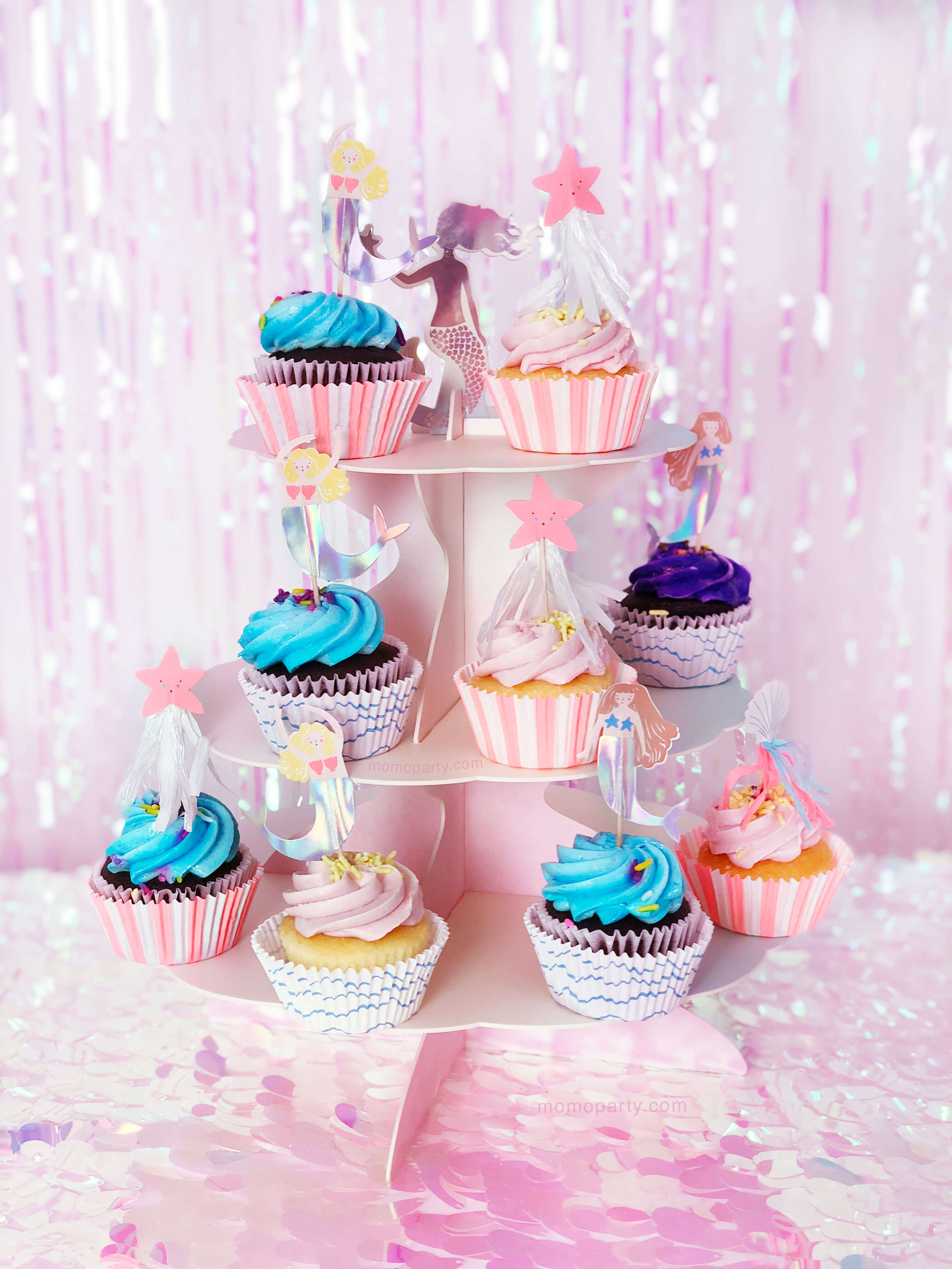 cupcakes with Mermaid themed toppers on the pink cake stand