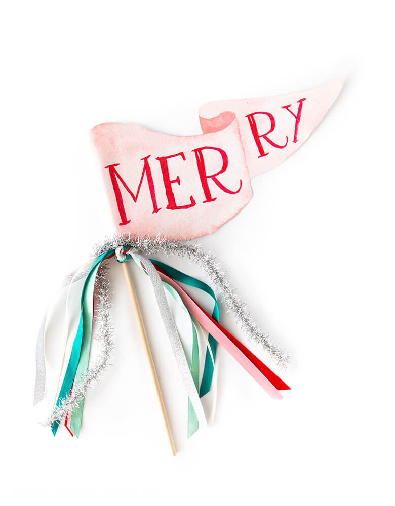 Merry Party Pennant by Cami Monet. This beautiful Pennant is made in United States of America, with Size: 10 x 5 inches, Pennants are made of 120 lb. luxe watercolor texture paper with original watercolor illustration of word "Merry" for extra whimsy. Green, pink and red Ribbon and sparkle garland on the rod. The Merry party pennant is perfect for celebrating Christmas!