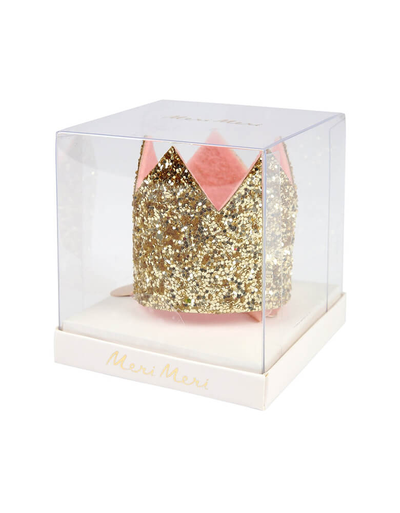 Mini Gold Glitter Crown Hair Clip by Meri meri in the clear package. Embrace your inner princess by sporting this fantastic gold glitter crown hair clip. featuring Gold glitter fabric with pink felt lining and Gold tone hair clip