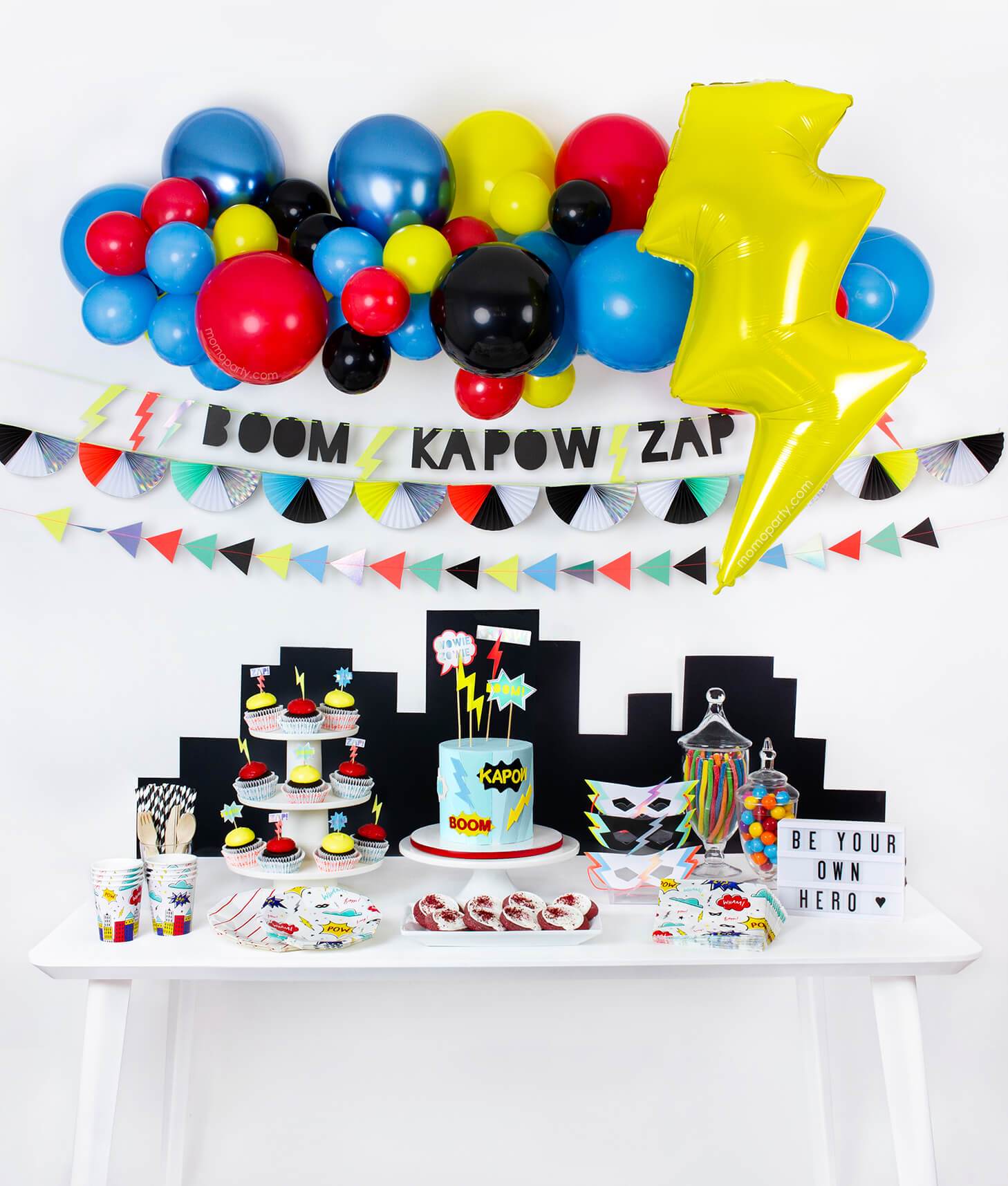 modern boy and girl superhero themed birthday party idea with balloon garland, Lightning Bolt Foil balloon, Super hero Slogan Garland and tablewares