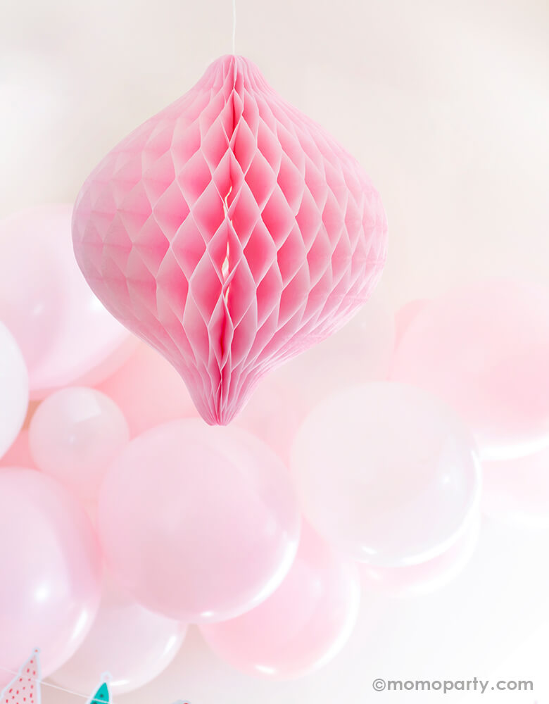 Pastel christmas party set up with pastel matt pink balloon garland and Light Pink Oval Spinning Top Honeycomb Ornament Decoration 