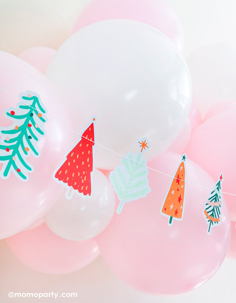 My mind's eye 6 ft long Holiday Fa-La-La Christmas Tree Banner, featuring many cute graphic die-cut tree. pair with pastel pink and white colored latex balloon garland for a fresh cute pastel pink holiday party, kids christmas party and all christmas related celebrations