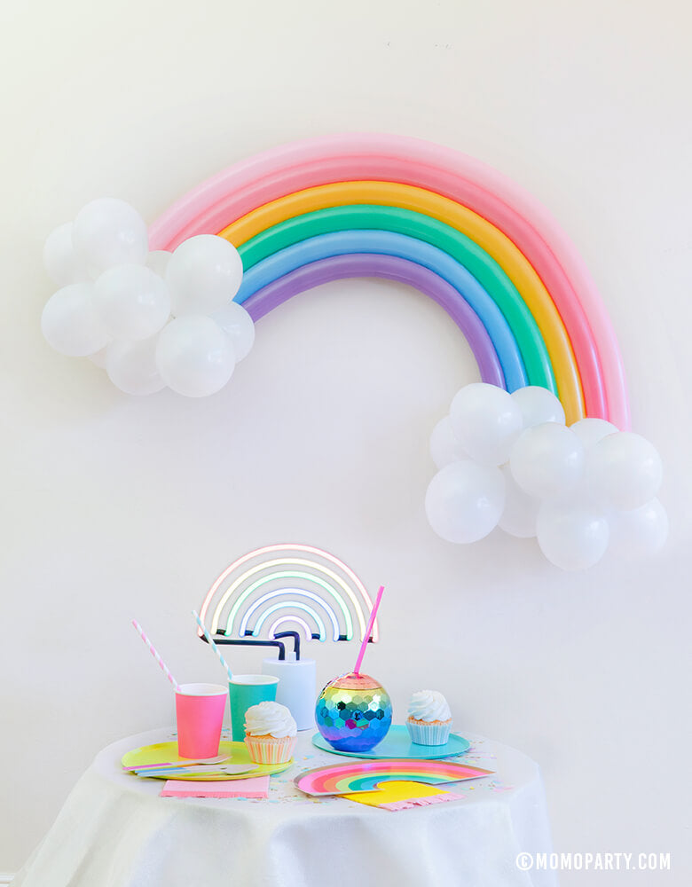 Modern Pastel Rainbow Party At home Look with Rainbow Balloon Animal with Rainbow color Qualatex twisting balloons and 5 inch white latex balloons as cloud for wall decoration, A Sunnylife Rainbow neon light, Oh Happy Day Rainbow shape plates, Rainbow Large Plates Set, Rainbow paper cups, Blush Rainbow Ombre Disco Ball Tumbler, Hip Hip Hooray Fringe Small Napkins, Cupcakes for rainbow vibe celebration, party decoration, Rainbow birthday party, Summer party, Modern party celebration.
