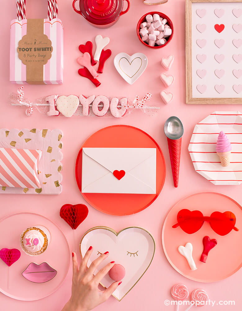 super sweet Valentines day collection pink table, full of pink and red paper plates, heart shaped plates, heart shaped latex balloon, red stripe paper plates, heart shaped sunglass, I heart you candy, toot sweet pink stripe party bags, LE CREUSET Mini Round Cocotte, red ice cream cone shaped scoop, heart letter box, candies, cotton candies, Macarons for a sweet valentine's day party, Rom-Com Movie Night, Galentine's Day