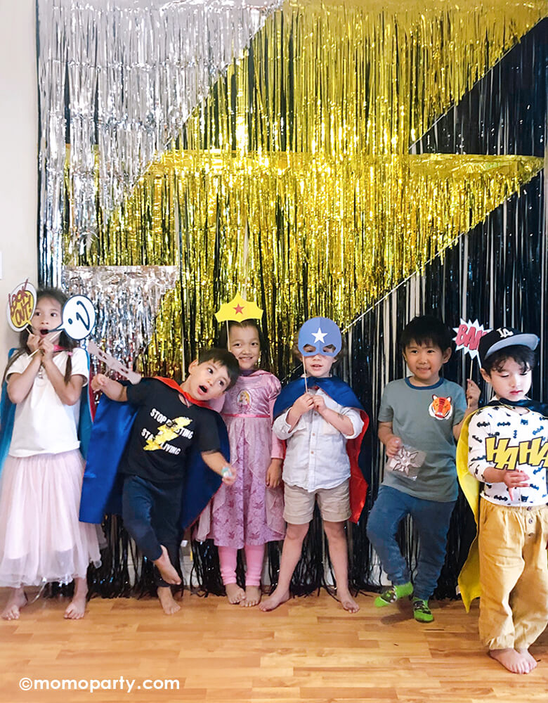 Many cute kids holding My Minds Eye - Paper Love Comic Pop Photo Props, taking photo in front of a lighting backdrop photobooth