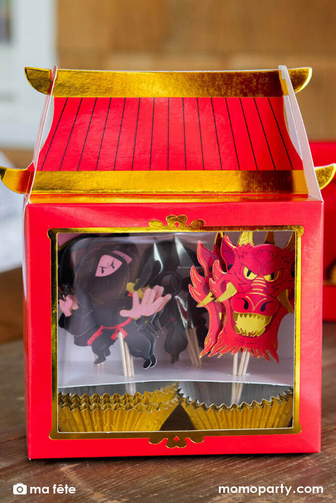 Momo Party's Ninja Cupcake Kit by Ma Fête. Set of 16 toppers, featuring Ninjas, Dragon head, ninja darts designs in a Red Temple shaped box package . The toppers include gold foil details to give cupcakes an eye-catching finish. They are perfect for a Ninja themed birthday party