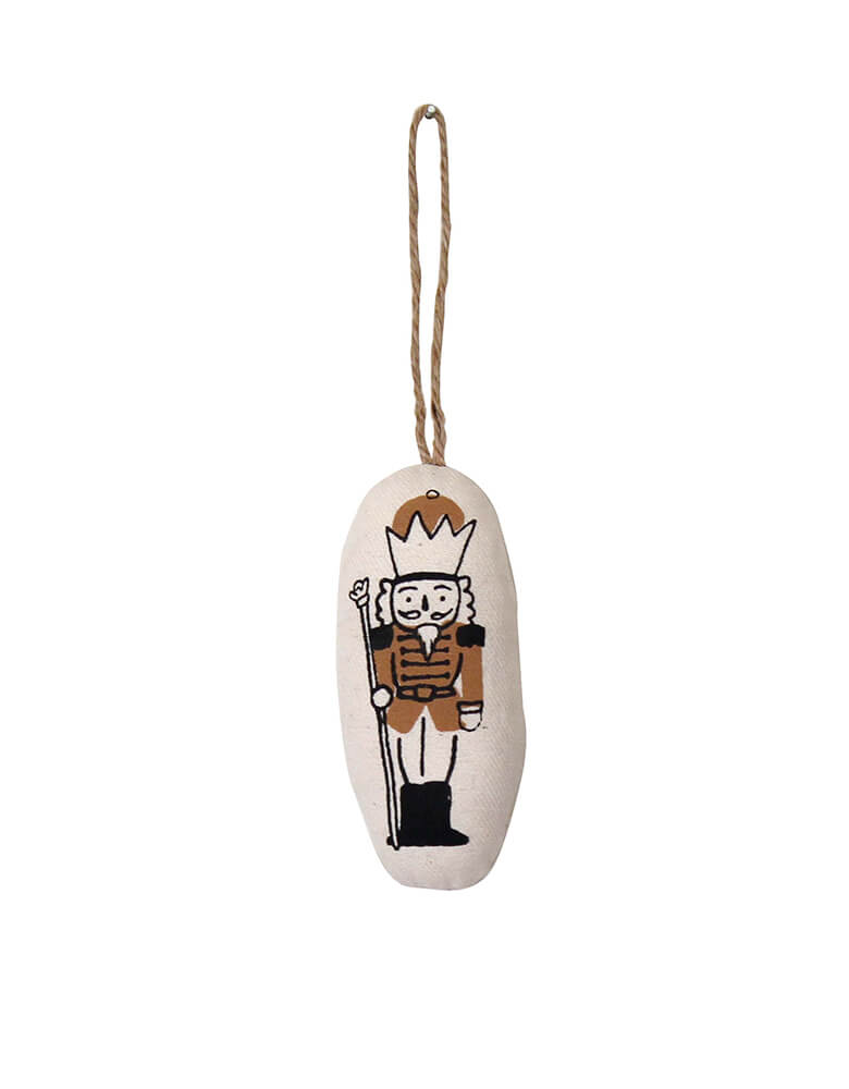 Nutcracker Ornament by Imani Collective. Size: 2.5 x 4 inches. This modern plush Natural canvas with Nutcracker printing was sewn and screen printed by hand on natural canvas by local artisans in Kenya. This modern Nutcracker canvas ornament is perfect for this Holiday season, christmas tree decoration, holiday small gift, Nutcracker lover. Sold by Momo party store provided modern party supplies, boutique party supplies, chic holiday party supplies and high end party supplies