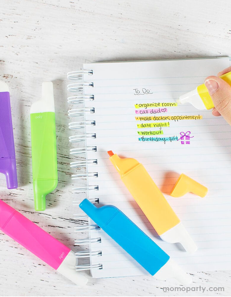 OOLY Do-Overs Erasable Highlighters in use, highting a to do list on the notebook with colorful bold highlighters around the table