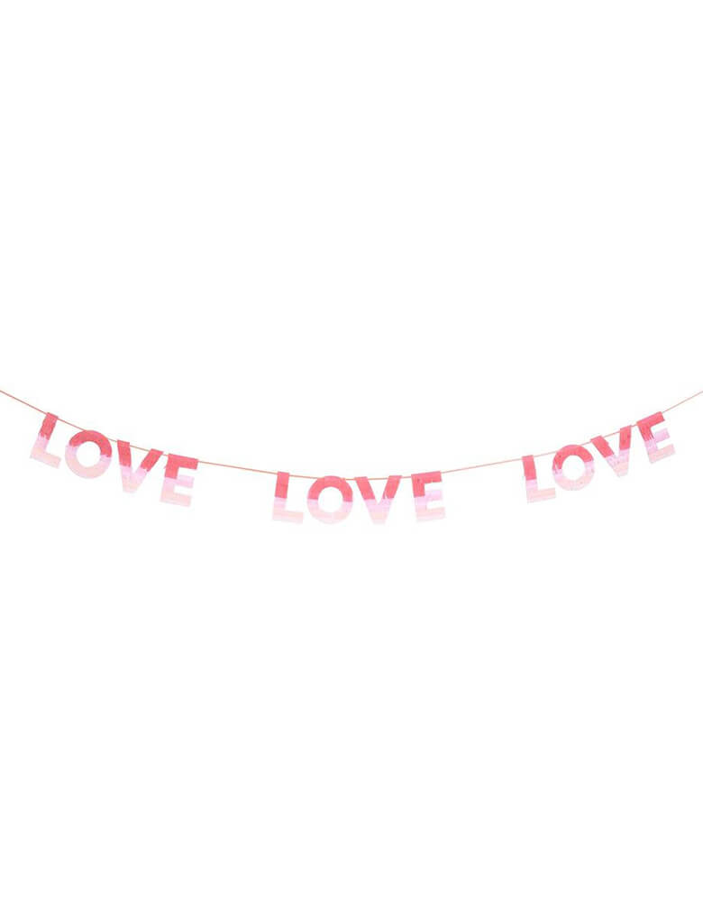 Meri Meri Ombre Love Garland with fringed tissue paper, with each letter having colors in red, peach and pink to achieve an ombre effect. Perfect for a Valentine's Day or Galentine's Day celebration 
