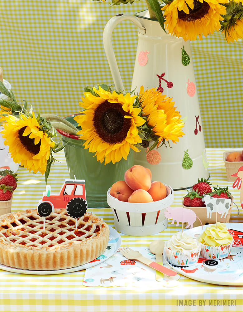 Farm themed party with  Apple Pie with On the Farm Tractor Candle, animal cupcake kit, sunflowers on the dessert table