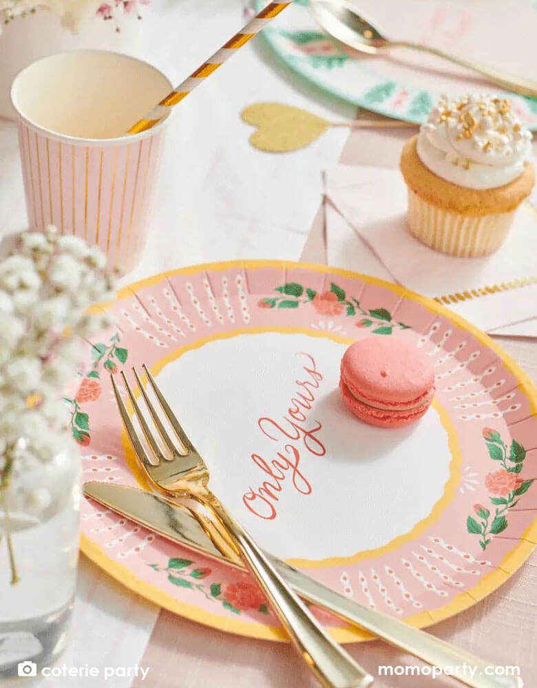 A beautiful love themed party table featuring Momo Party's 9 oz pale pink pinstripe party cups by Coterie Party and 9" All You Need is Love" Large Plates with a message of "Only Yours" on the plate. With a tableset with pastel pink themed tableware with heart shaped elements, it's a perfect inspiration for a Valentine's Day celebration.