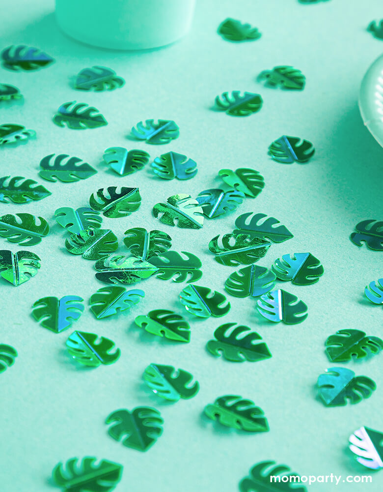 Party Deco Green Palm Leaf Confettis on a dinosaur themed party table with green table cloth. This confetti features Palm leaf shape cutouts with green foil. Add some fun to your jungle, dinosaur or tropical themed party by spreading this set of palm leaf confetti in metallic green to your table! party supply accessories Sold by Momo party store provided modern party supplies, boutique party supplies, chic holiday party supplies and high end party supplies