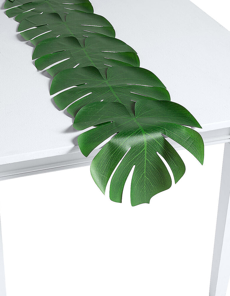 Fun Express Palm Leaf Table Runner. This 90 inches long plastec green palm leaf runner is Perfect for your buffet table or any party table, this table runner features cutouts like a real palm leaf! 
