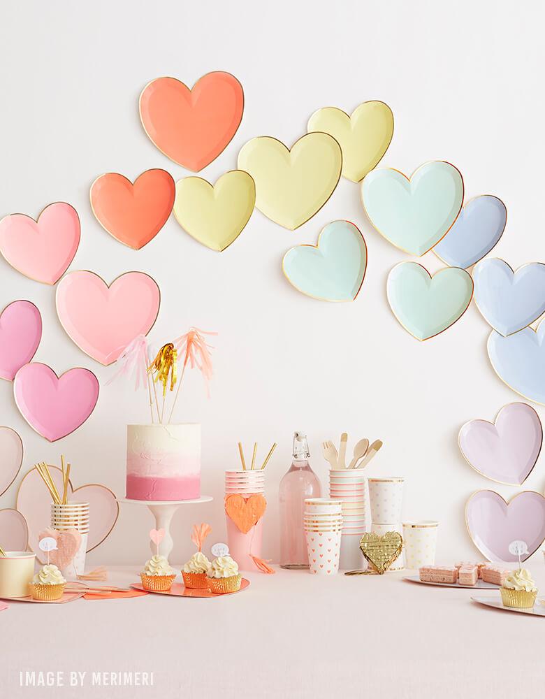 Valentines day party ideas of backdrop wall decoration with Meri Meri Party-Palette-Heart-Large-Plates, pink naked cake, cups, desserts