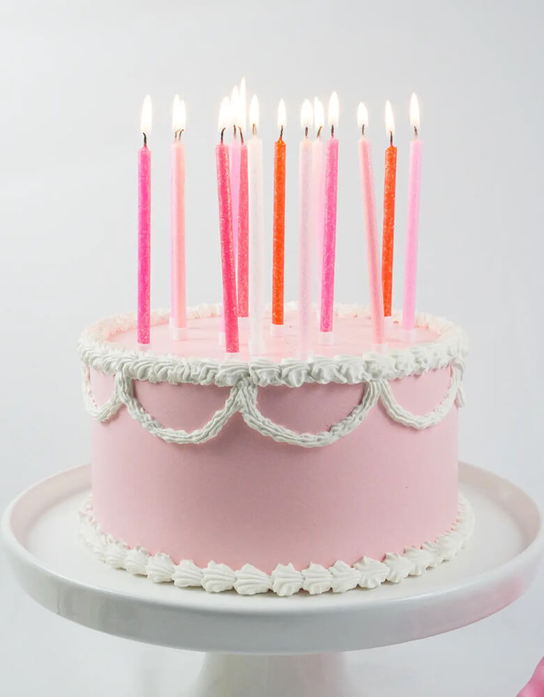 Momo Party's Tall Pink Gradient Candle Set by Party Partners on a pink birthday buttercream cake, these candles are perfect for girl's birthday parties.