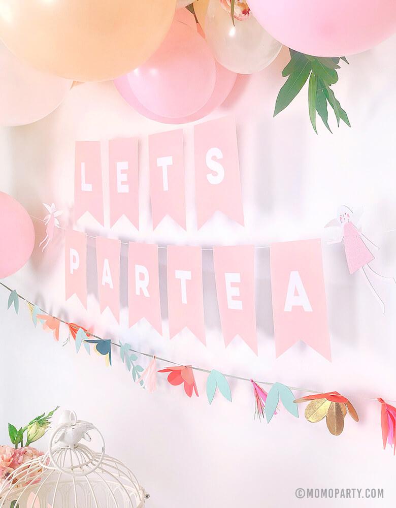 Pastel Tea Party decorated with pastel balloon garland with flowers, My Minds Eye's Pink Letter banner with customized with "Lets Partea" and Meri Meri Fairy Garland