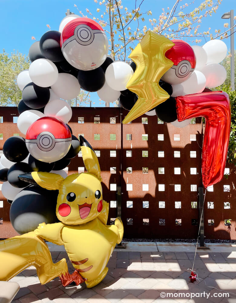 Pokemon Party with a Black and white latex balloon garland, mix with Pokemon Pokeball Orbz Foil Balloon and Lightning Bolt Foil Balloon. A anagram 57" Pokemon Pikachu Airwalker Foil Balloon stand on the left, and a  Large Number 7 Red Foil Mylar Balloon on the right side. A modern cute backdrop for a 7 years' boy pokemon themed birthday party