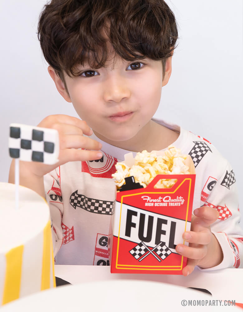 boy eating popcorns with a Fuel-Treat-Favor-Boxe at a Car themed birthday party