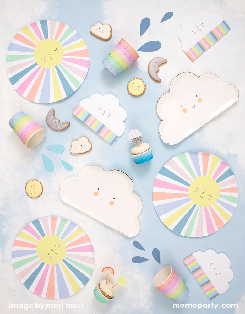 A sunshine themed birthday table filled up with Meri Meri Rainbow Sun Dinner Plates, Rainbow Sun Cloud Napkins, Happy Cloud Plates, Rainbow Sun Cups, Happy Weather Cupcake Kit with cute cloud, moon, sun shaped cookies. These sunshine themed collection featuring a sweetly smiling face and colorful fringed details. They are perfect for any celebration, including baby showers or you are my sunshine themed birthdays or any kids birthday.