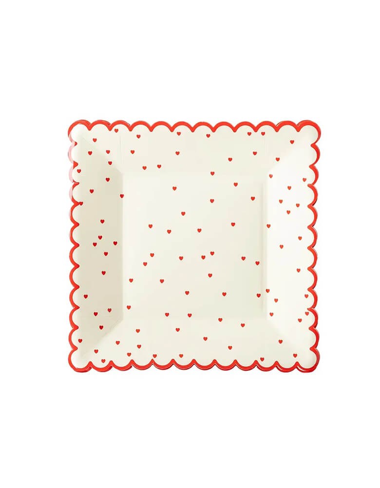 Momo Party's 8" square scattered red heart scallop plate by My Mind's Eye, featuring a scalloped edge and a pretty scattered heart design these plates are the perfect way to show your guests some love, or pass out sweet Valentine's Day cookies that are sure to spread cheer to your loved ones.