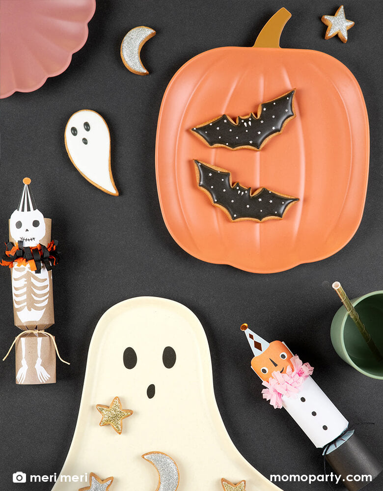 Halloween table decorated with Meri Meri reusable bamboo pumpkin plate and Reusable Bamboo Ghost Plate, ghost , moon and stars cookies, and Vintage Halloween Medium Crackers. These reusable plates are made using naturally renewable bamboo, this large sustainable plates are reusable, durable and dishwasher safe. It's ideal to serve savory and sweet treats on for a Halloween party or Thanksgiving Friendsgiving gathering