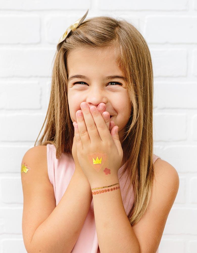 Girl waring My Minds Eye's Princess Temporary Tattoos  on her arms and hand in a princess party