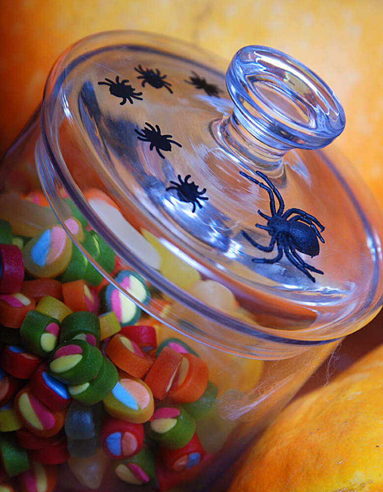 Party Deco Halloween Spider confetti in a candy jar. also you can add some fun to your Halloween party by spreading this set of spider confetti to your table