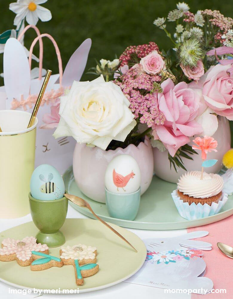 Easter egg party kid's table fill bunny napkins, plates, flower cookies, bunny party bags, a plate with flowers and cupcakes, eggs decorated with Meri Meri Spring Bunny Egg Decorating Tattoo Kit. These adorable tattoos featuring 3 sheets in each kit, 27 tattoos in total with 9 darling water color designs of bunnies, carrots, flowers, birds and bees character. decorating them on your eggs, Make your Easter eggs look amazing this year's Easter day, easter party