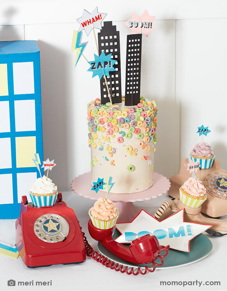 Meri Meri Superhero Cake Toppers. Featuring towering skyscrapers with cut out windows, a lightning bolt, and classic comic book words, "Boom!", "Zap" and "Wham!".