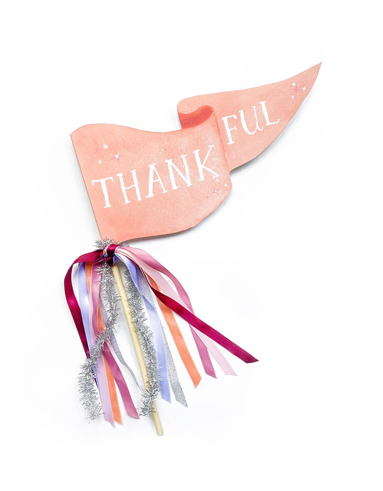Thankful Thanksgiving Party Pennant by Cami Monet. This 10 x 5 inches handmade pennant featuring a handwriting "Thanksful" text with watercolor background in pink on the 120 lb. luxe watercolor texture paper, with orange, pink, purple and silver Ribbon and sparkle garland adding details on the rod. This high quality made party pennant is so cute for celebrating Thanksgiving ! Hold it in a photo or pop on a cake or use as your Thanksgiving parties, Friendsgiving parties and fall celebrations