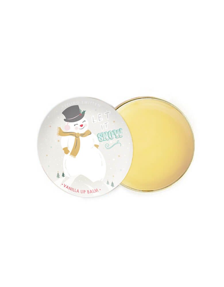 Feeling Smitten - Vanilla Snowman Lip Balm. Featuring featuring beeswax and shea butter in a small rounded tin with snowman graphic on it. The weather outside may be frightful but your lips will feel delightful with this vanilla-kissed lip balm, naturally hydrate and protect against dry skin. use yourself or kid, sent it as gift to your loved one, it also a perfect for stocking stuffers 