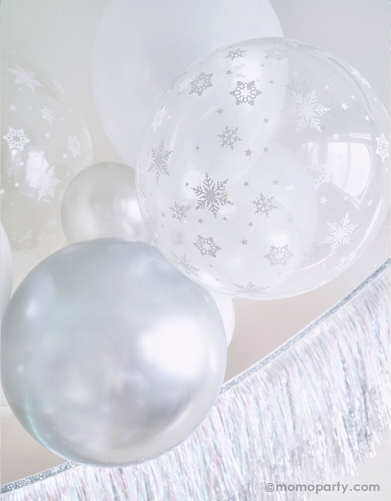 Close up details of White Christmas Balloon Cloud, featuring with 11 inch and 5 inch Qualatex Pearl white latex balloons, Chrome silver latex and clear with Snowflake print latex balloon, Meri Meri Silver Tinsel Fringe Garland for a white christmas party, winter wonderland party, frozen party