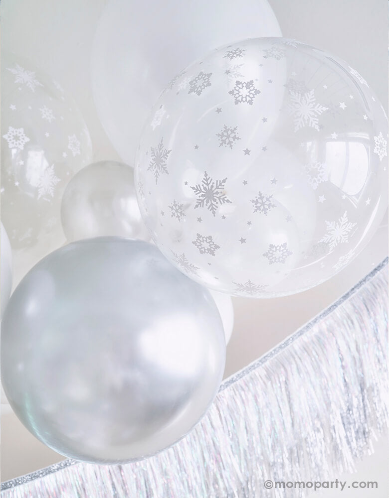 Close up details of White Christmas Balloon Cloud, featuring with 11 inch and 5 inch Qualatex Pearl white latex balloons, Chrome silver latex and clear with Snowflake print latex balloon, Meri Meri Silver Tinsel Fringe Garland  for a white christmas party, winter wonderland party, frozen party