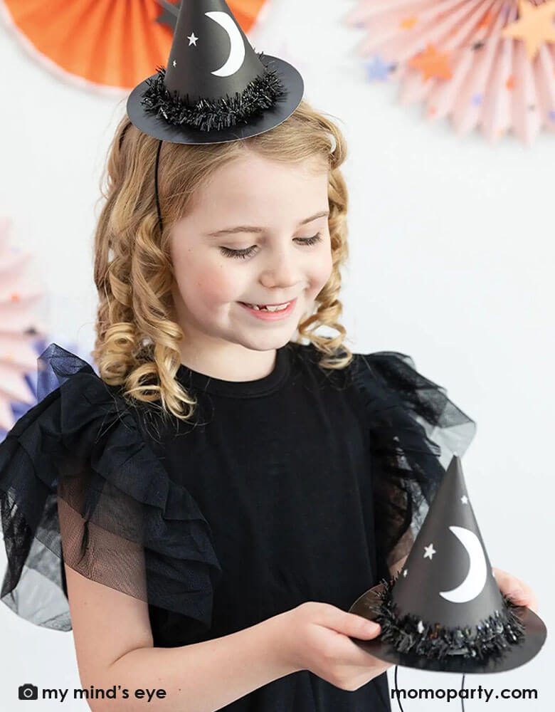 Witching-hours-witch-party-hats-girl-holding-hats