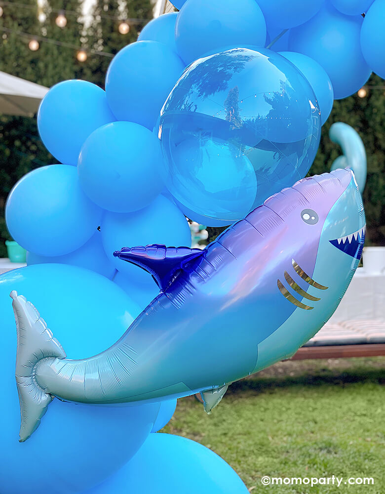 Close up of Shark themed birthday outdoor party, blue colored balloon cloud with shark foil ballon and Crystal Clearz Blue Orbz Non-Foil Balloon